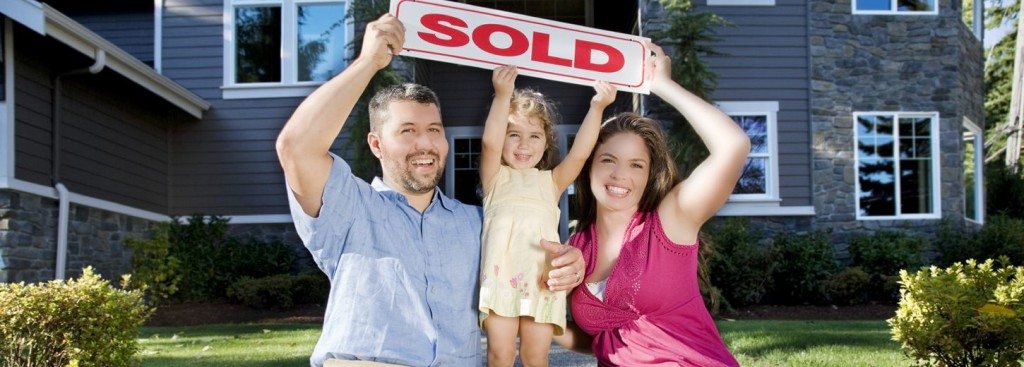 Smiling_Family_with_Sold_Sign